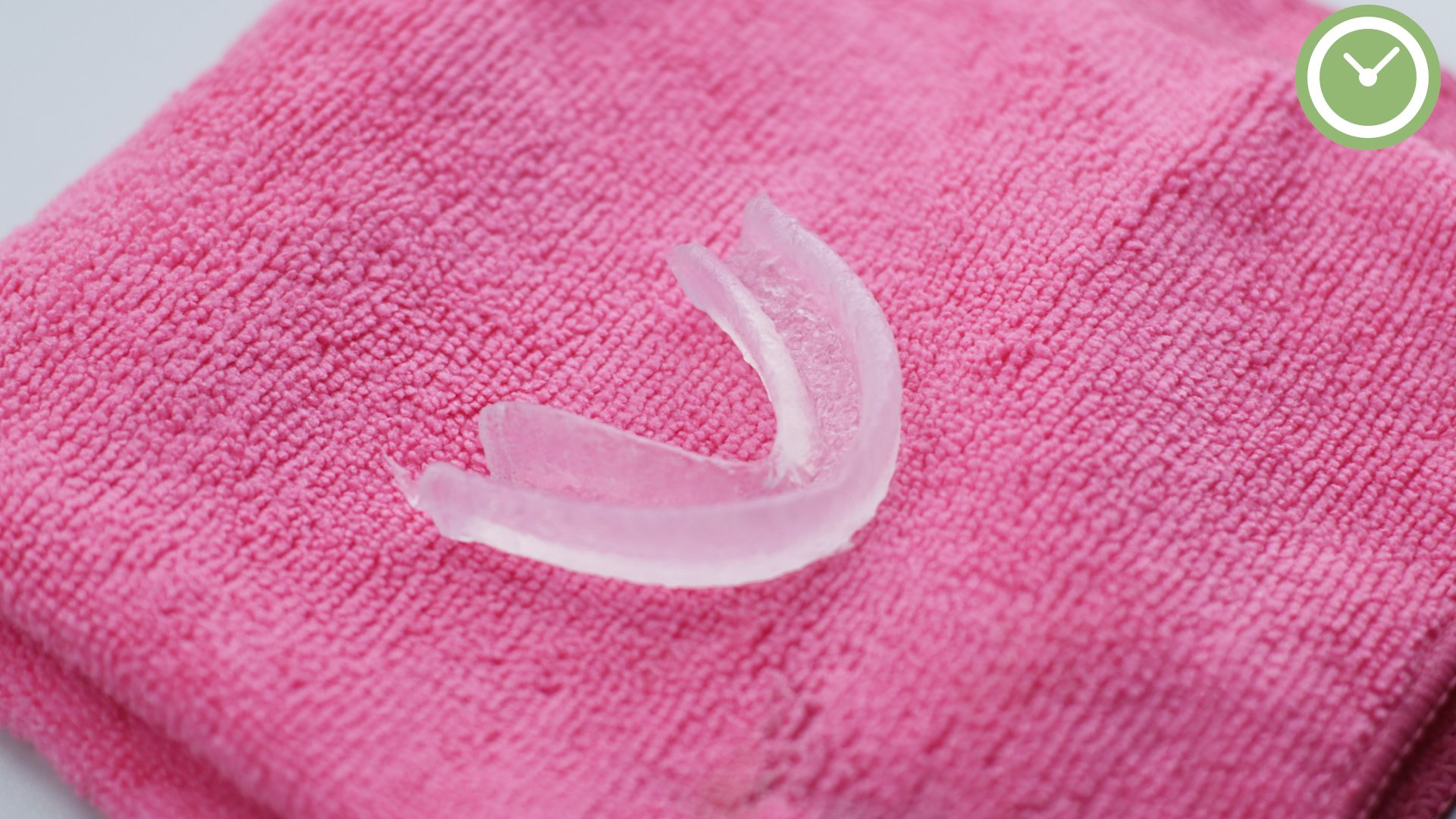 Boil and bite mouthguard held in hot water to soften the thermoplastic before you mold a mouthguard for a custom fit