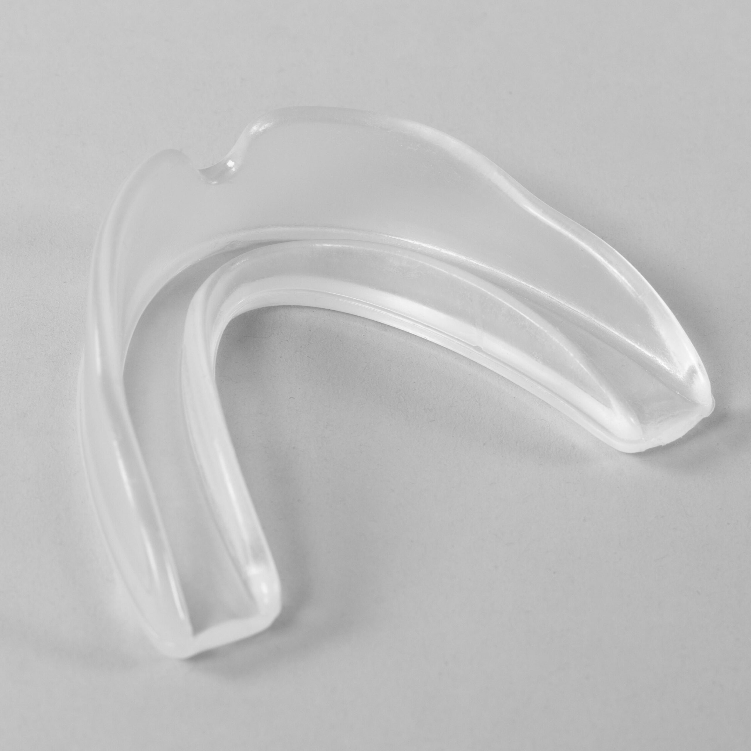 Sports mouthguard submerged in hot water waiting to soften so you can mold a mouthguard around your teeth