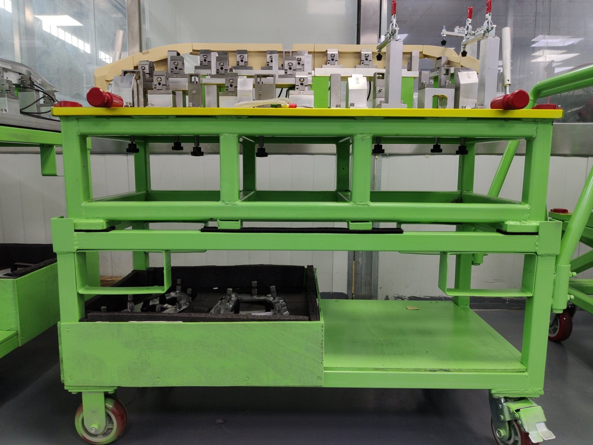 Welding fixture with datum buttons and clamps holding sheet metal parts for assembly